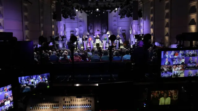 audience view of representatives on stage