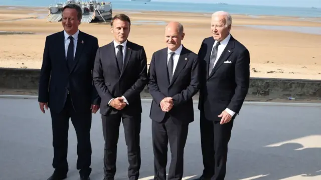 Foreign Secretary David Cameron, France's President Emmanuel Macron, German Chancellor Olaf Scholz and US President Joe Biden attended a commemorative ceremony on Omaha Beach in France