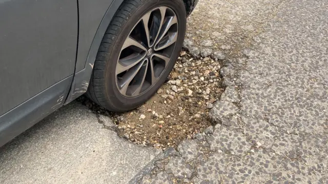 car tyre in pothole