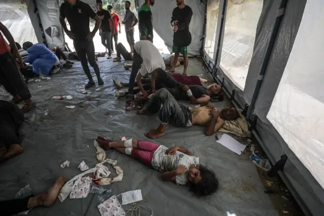 Injured Palestinians at Al Awda hospital during an Israeli military operation in Al Nusairat refugee camp in the central Gaza Strip 08 June 2024