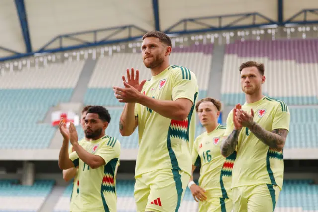 Wes Burns and Wales team-mates applaud their fans in Gibraltar