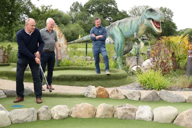 Ed Davey plays mini golf