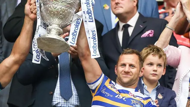 Rob Burrow hold up the Challenge Cup Trophy after winning it