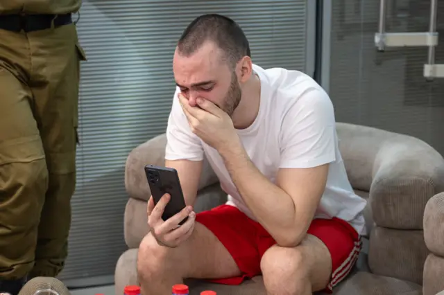 Andrei Kozlov, a Russian who lives in Israel, breaks down as he speaks with his loved ones over the phone