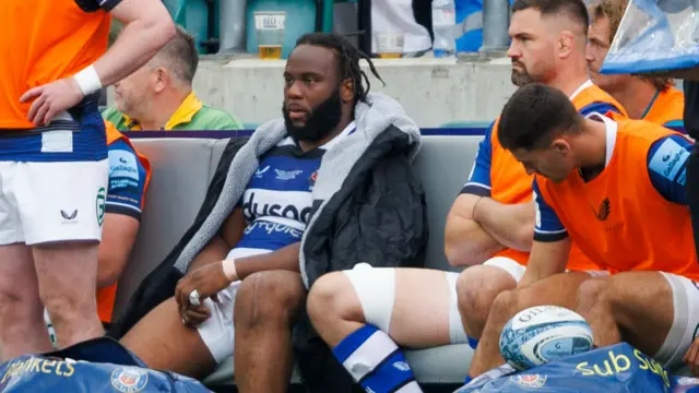 Beno Obano sits down after being sent off