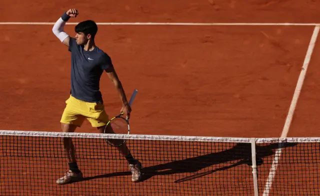 Carlos Alcaraz fist pumping on clay