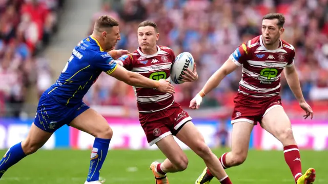 Jai Field is tackled as Wigan attack v Warrington