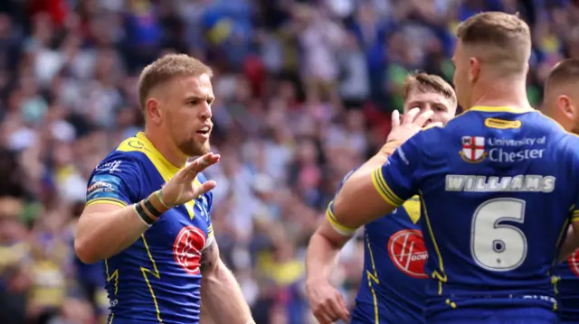 Matt Dufty celebrates his try for Warrington