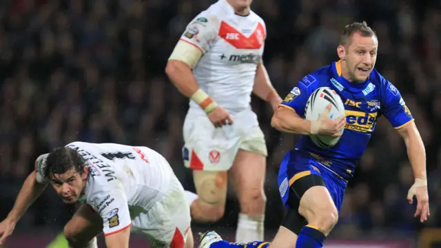 Rob Burrow races past St Helens' Paul Wellens in the 2011 Super League Grand Final