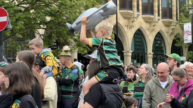 A young Saints fan with his own version of the Premiership trophy