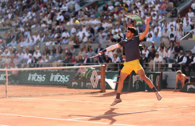 Carlos Alcaraz hitting a slice volley