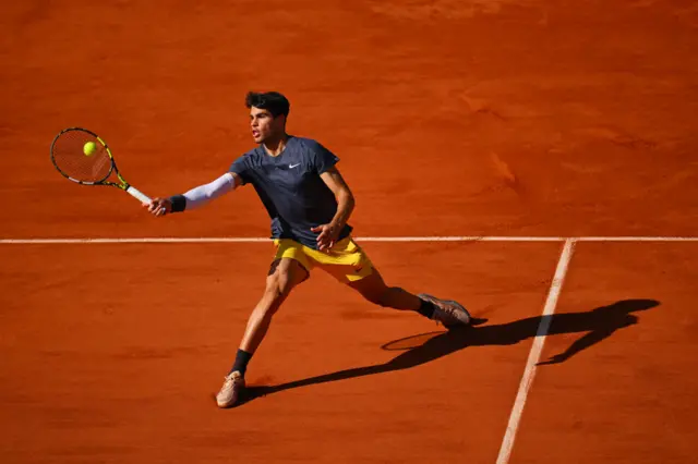 Carlos Alcaraz hitting a forehand volley