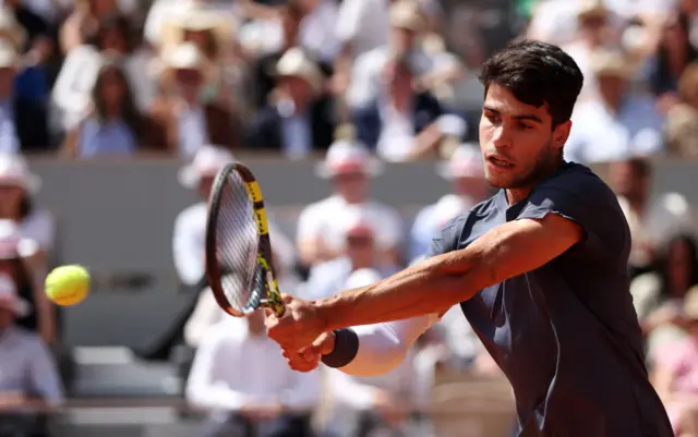 Carlos Alcaraz hitting a backhand