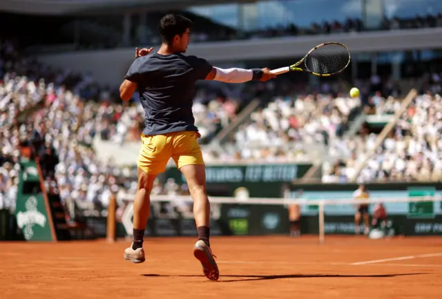 Carlos Alcaraz hitting a forehand