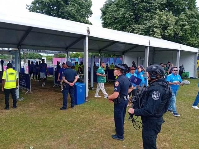 Police watch on as fans enter the cricket stadium in New York