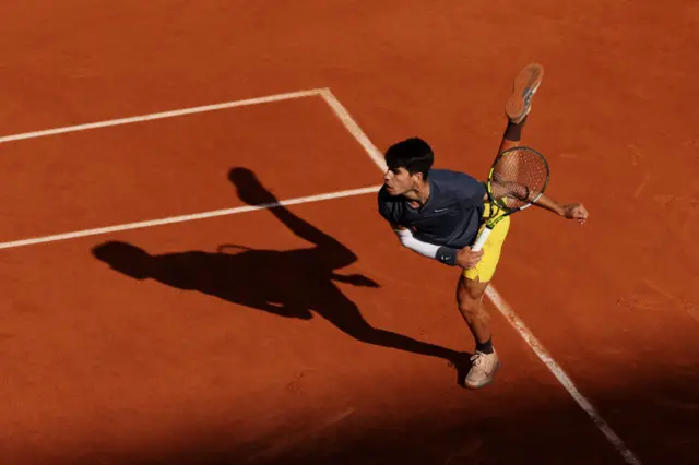 Carlos Alcaraz hitting a serve