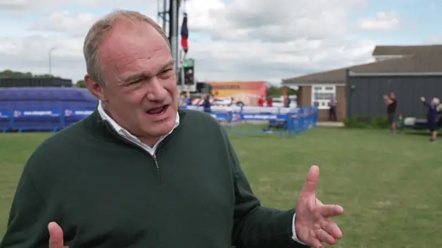 Sir Ed Davey speaks to reporters following his bungee jump