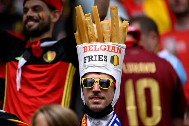 A Belgium fan with a Belgian fries hat on