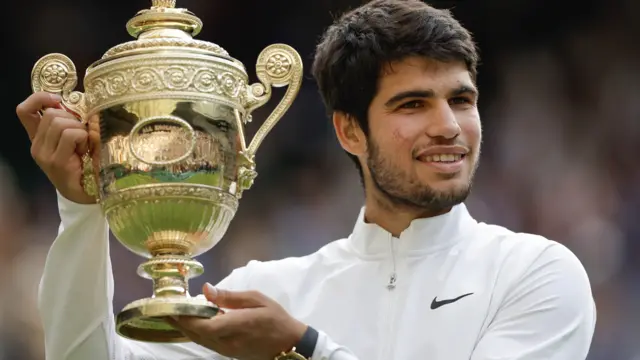 Carlos Alcaraz with the Wimbledon trophy