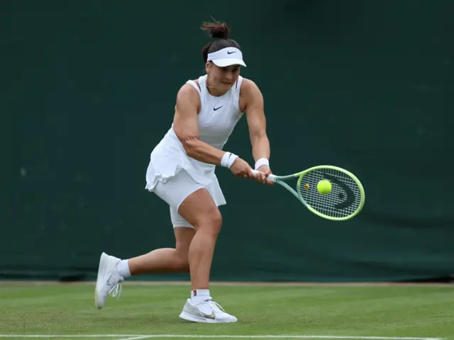 Bianca Andreescu hits a ball with her racquet