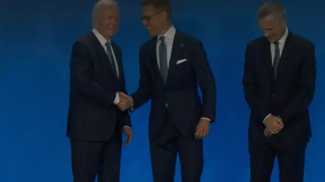 US President Joe Biden greets Finland's President Alexander Stubb (centre) as Nato Secretary General Jens Stoltenberg looks on