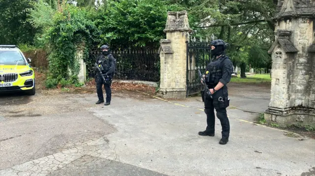 Armed police at cemetery