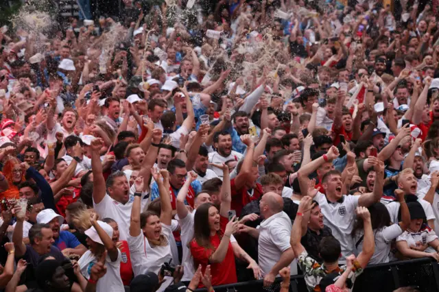 England fans celebrate after Harry Kane of England levels the score at 1-1 from the penalty spot during the UEFA EURO 2024 semi-finals