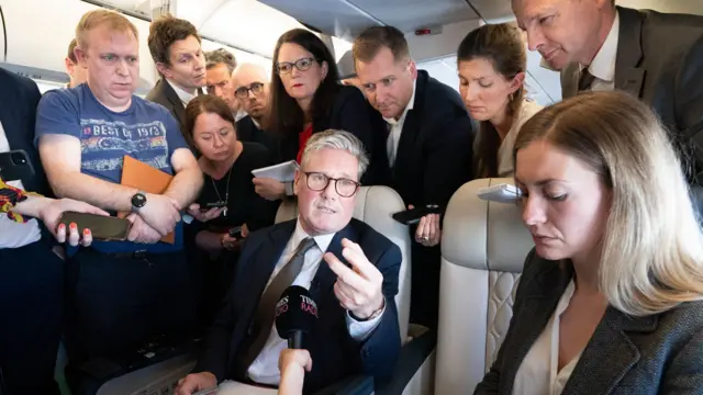 Prime Minister Sir Keir Starmer is surrounded by journalists on the plane to Washington DC