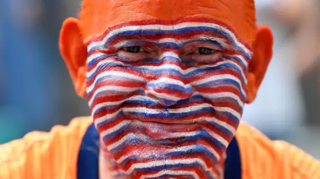 Netherlands fan poses for a photograph at downtown Dortmund ahead of the match