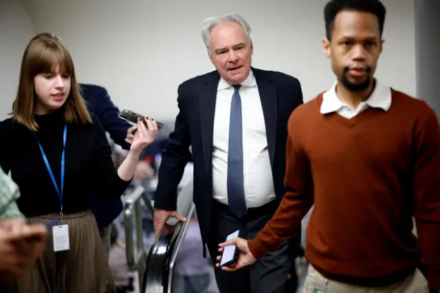 Tim Kaine is chased by reporters