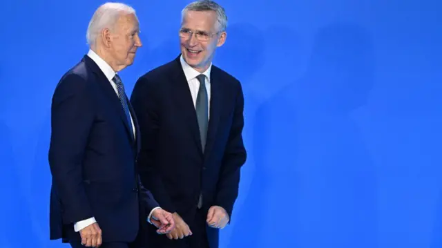 Joe Biden walks with Jens Stoltenberg