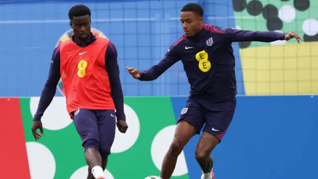 Marc Guehi (L) fights for the ball with England's defender #14 Ezri Konsa as they attend a training session during the UEFA Euro 2024 European Football Championship, at the team's base camp in Blankenhain, Thuringia, on June 22, 2024.