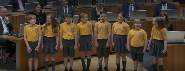 A choir of children singing in the Senedd