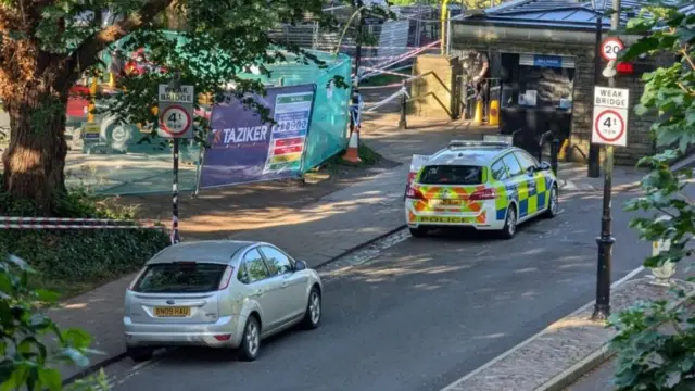 two police cars near the bridge