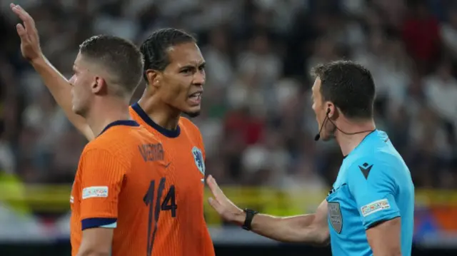 Virgil van Dijk speaks to the referee during the Netherlands' defeat by England at Euro 2024