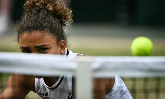 Jasmine Paolini watches her return hit the net