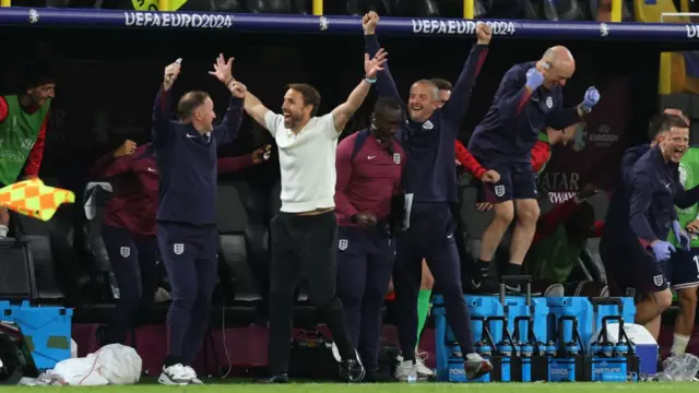 Gareth Southgate and his England staff celebrate in the dugout