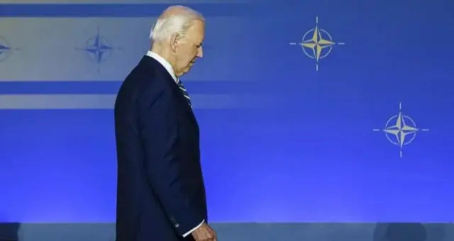 Joe Biden walking off stage at Nato