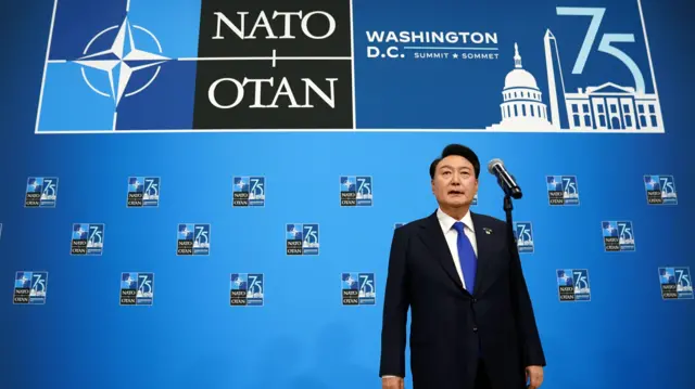 South Korean President Yoon Suk Yeol speaks to the media as he arrives at the NATO Summit in Washington