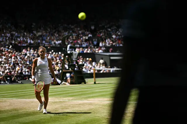 asmine Paolini walks to collect a ball