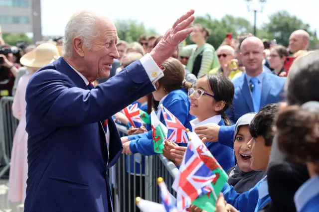 King Charles waves at a crowd of people who visited the Senedd