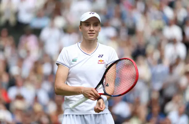 Elena Rybakina holds a tennis racquet