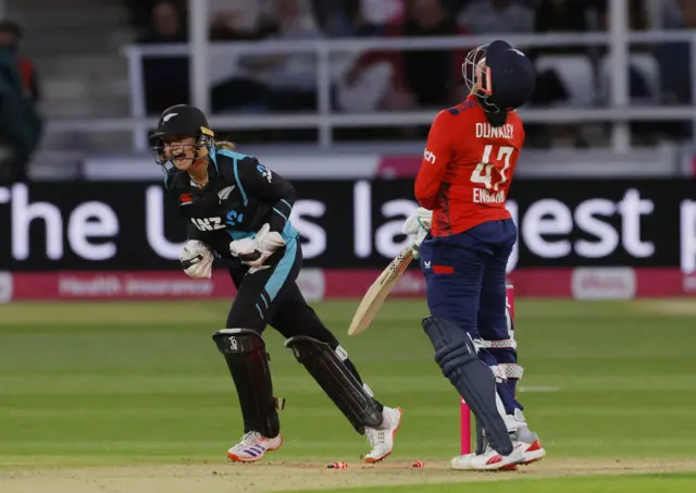 New Zealand's Isabella Gaze celebrates the wicket of England's Sophia Dunkley bowled out by Fran Jonas