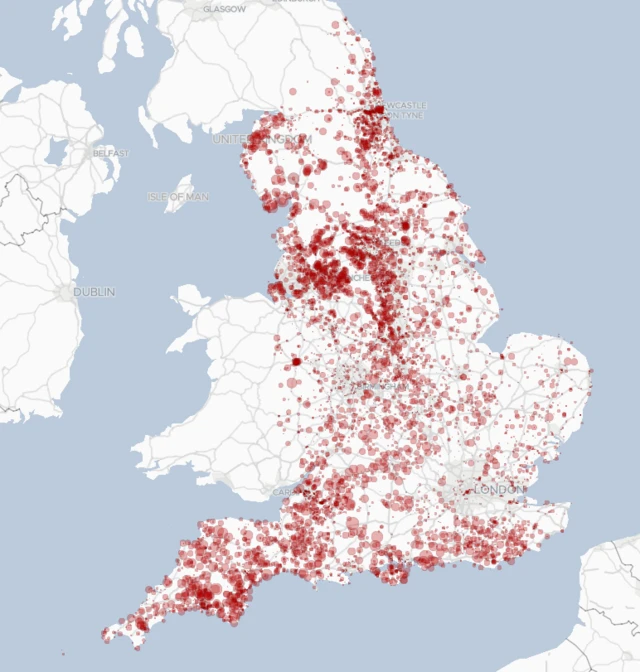 A map with red dots showing storm overflows in England in 2023, scaled by total hours of discharge