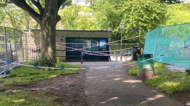 Police tape blocks a pathway near the bridge on the Bristol side.