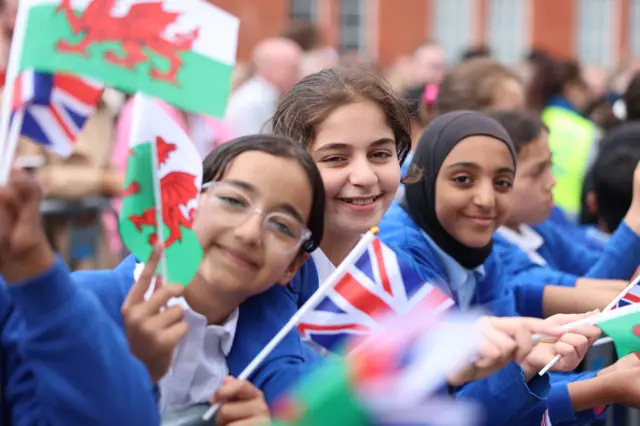 Children wave Welsh and British flag