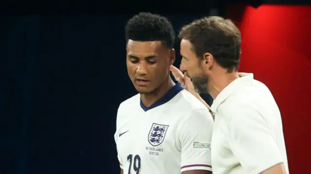 England's Gareth Southgate speaks to Ollie Watkins before bringing him on against the Netherlands