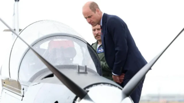 Prince William next to an aircraft