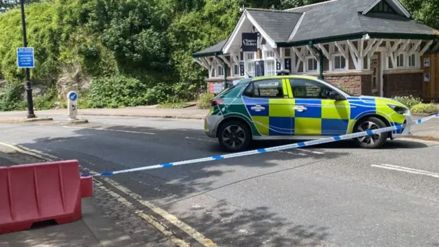 A police car blocking the road entrance to the bridge on the Bristol side