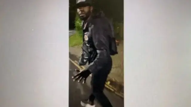 Image of man wanted by police wearing all black clothing
